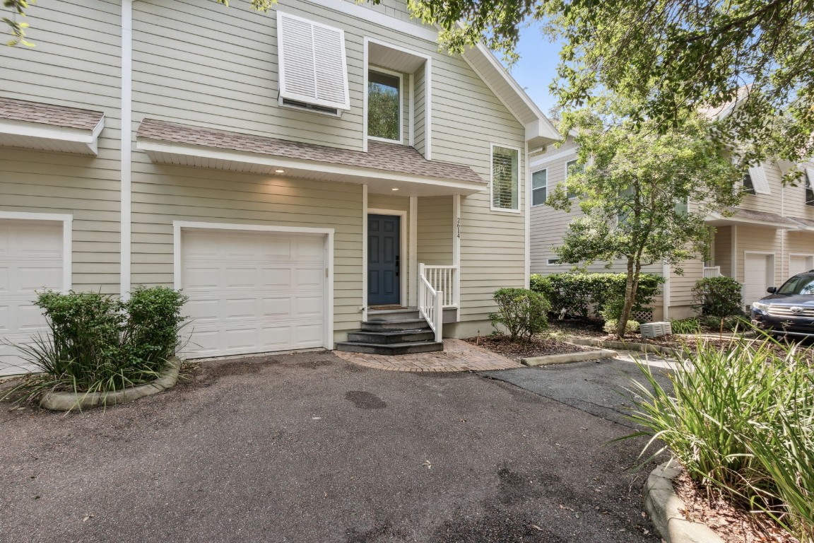 a view of a house with a yard and garage