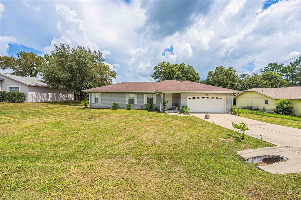 a front view of house with yard and swimming pool