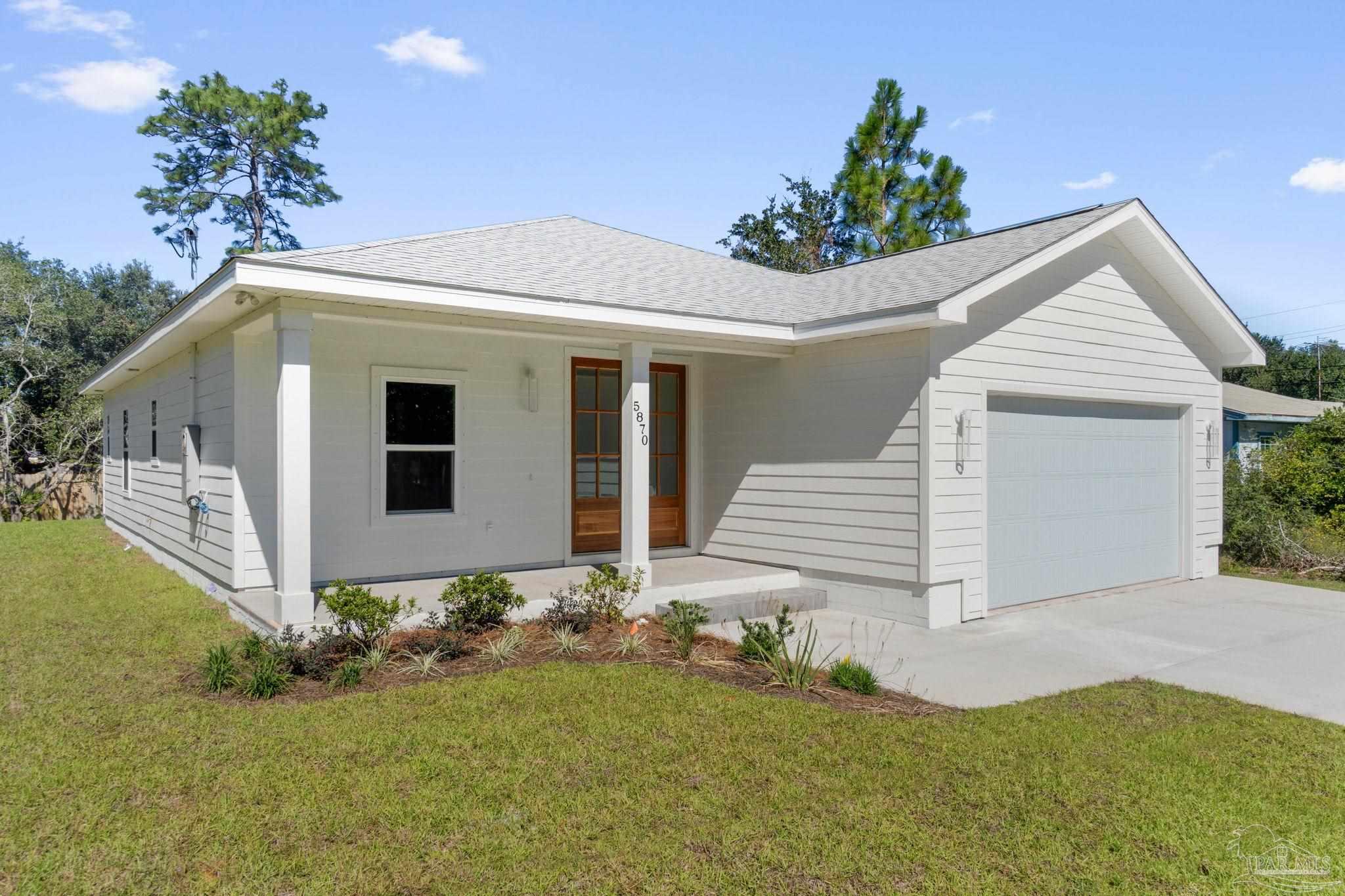 a front view of a house with a yard