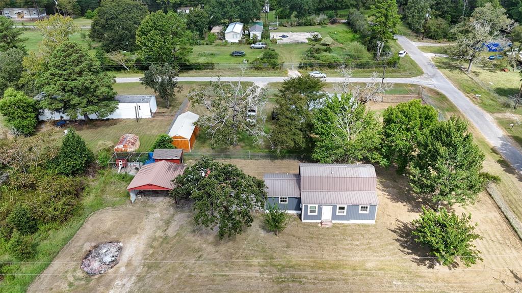 an aerial view of a house with a garden and lake view