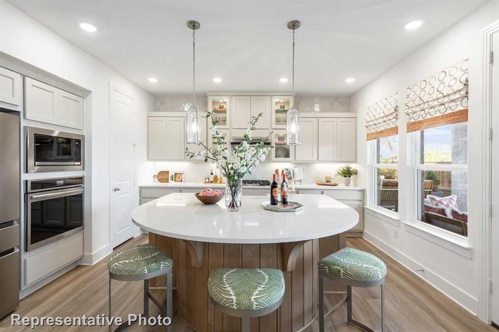 a large kitchen with a table and chairs