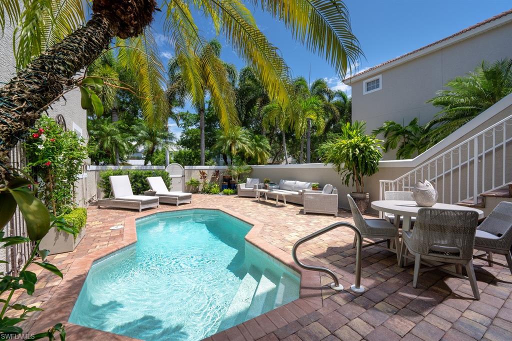 a view of a swimming pool with chairs