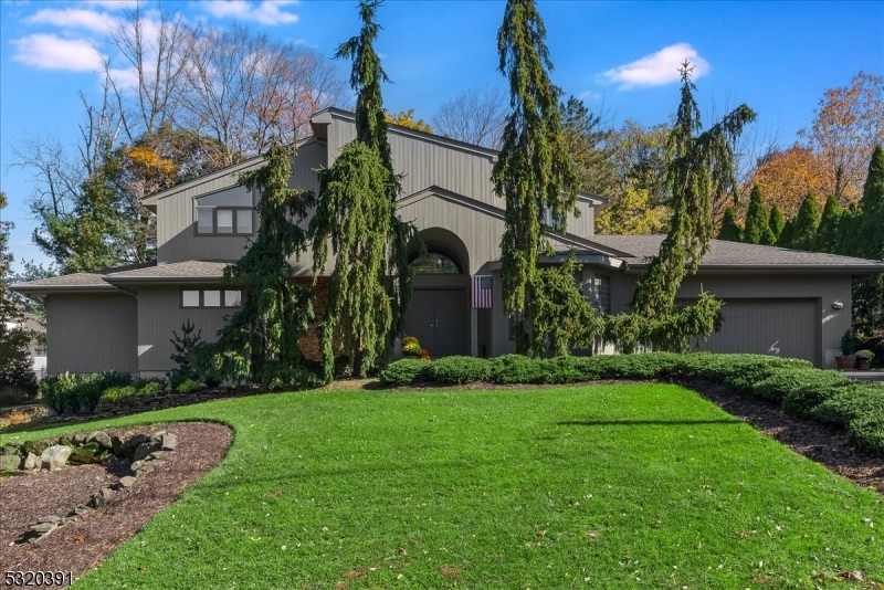 a view of a house with a yard and plants