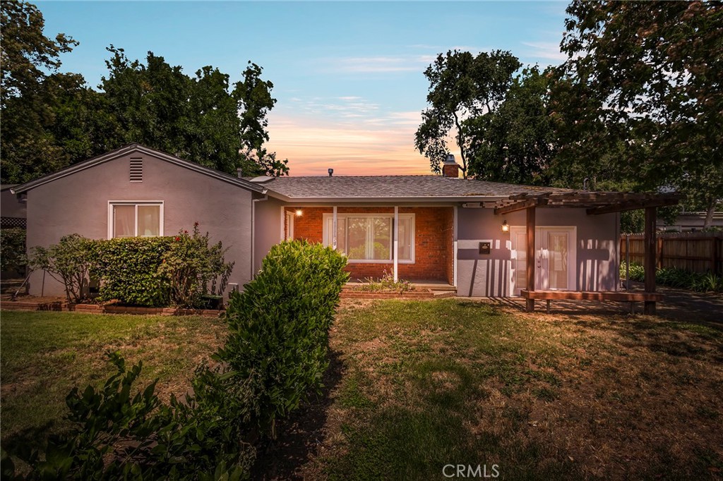 Evening Front Yard Shot.Very Sturdy Stucco and Brick Construction with At active Wisteria Vines located on a larg quarter acre, mostly fenced-in lot. 1532 Sqft 3/2 hom is also commercially zoned to run your own business from home!