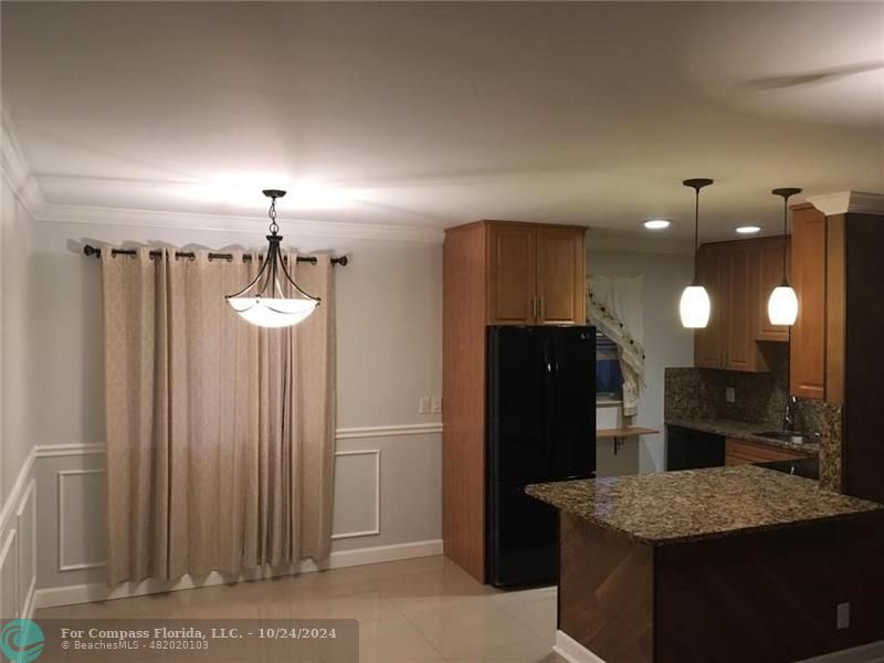 a kitchen with refrigerator and mirror