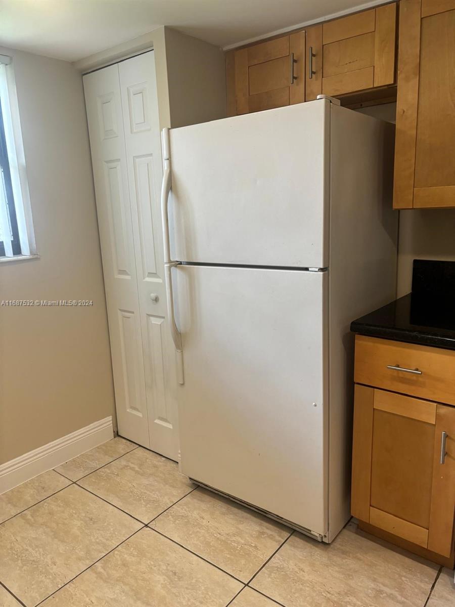 a white refrigerator freezer sitting in a kitchen