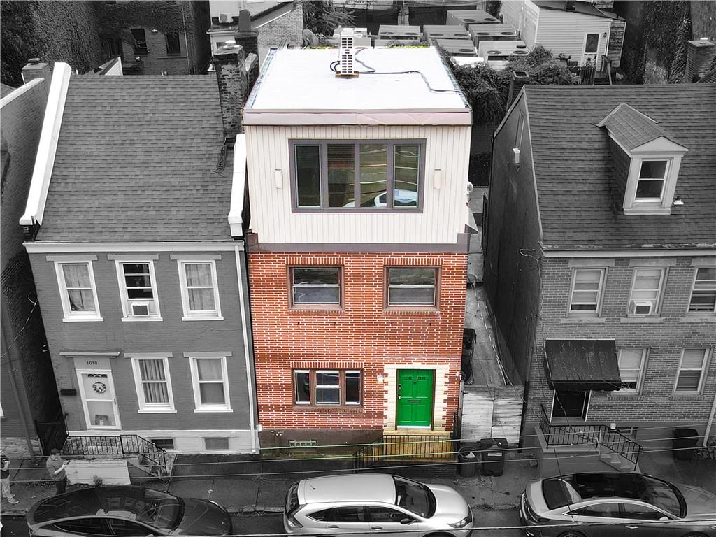 a white building with a window and a sink