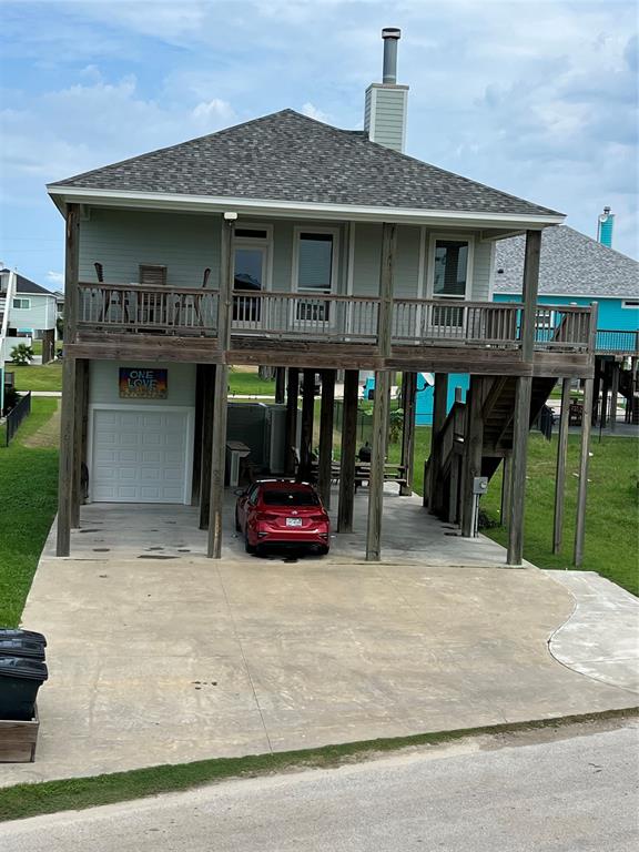 a view of a house with a patio and a yard