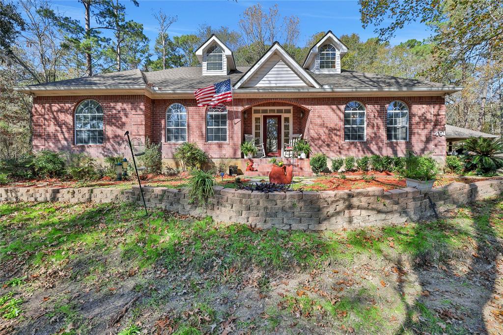 front view of a brick house with a yard