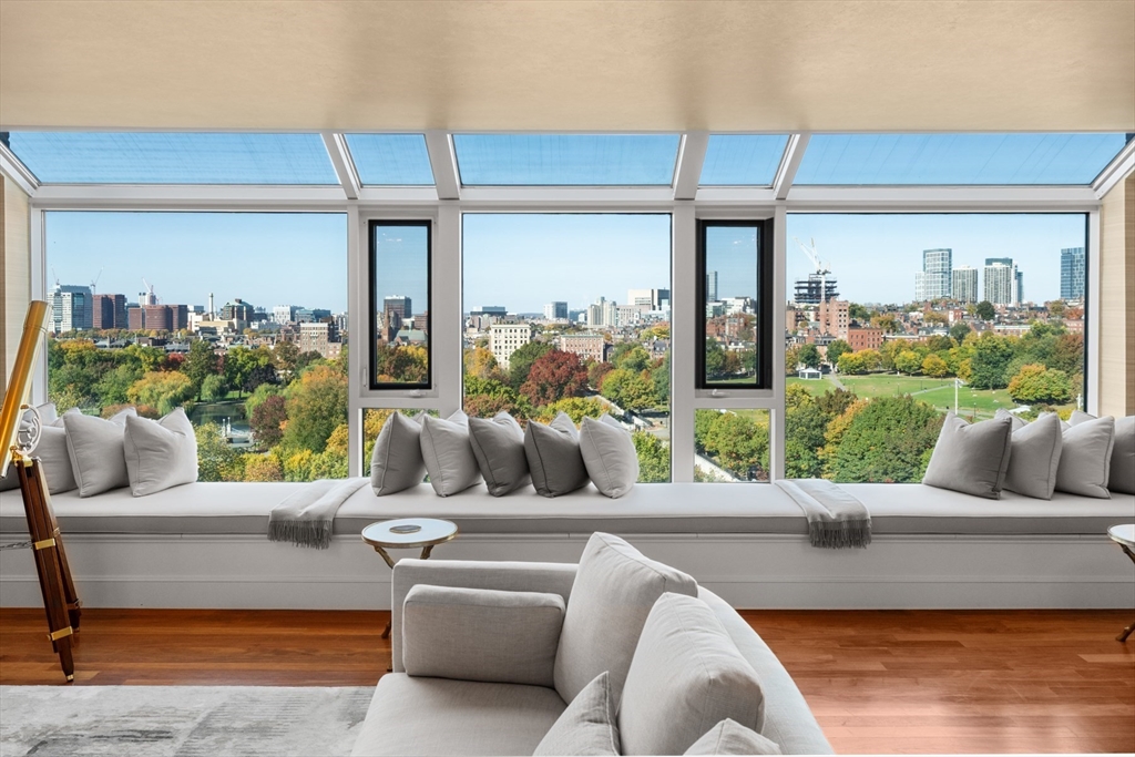 a living room with patio furniture and a garden