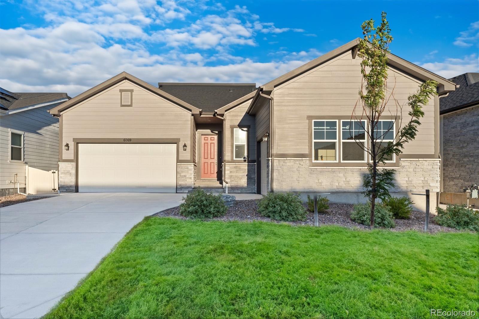 a view of front of house with a yard and garage