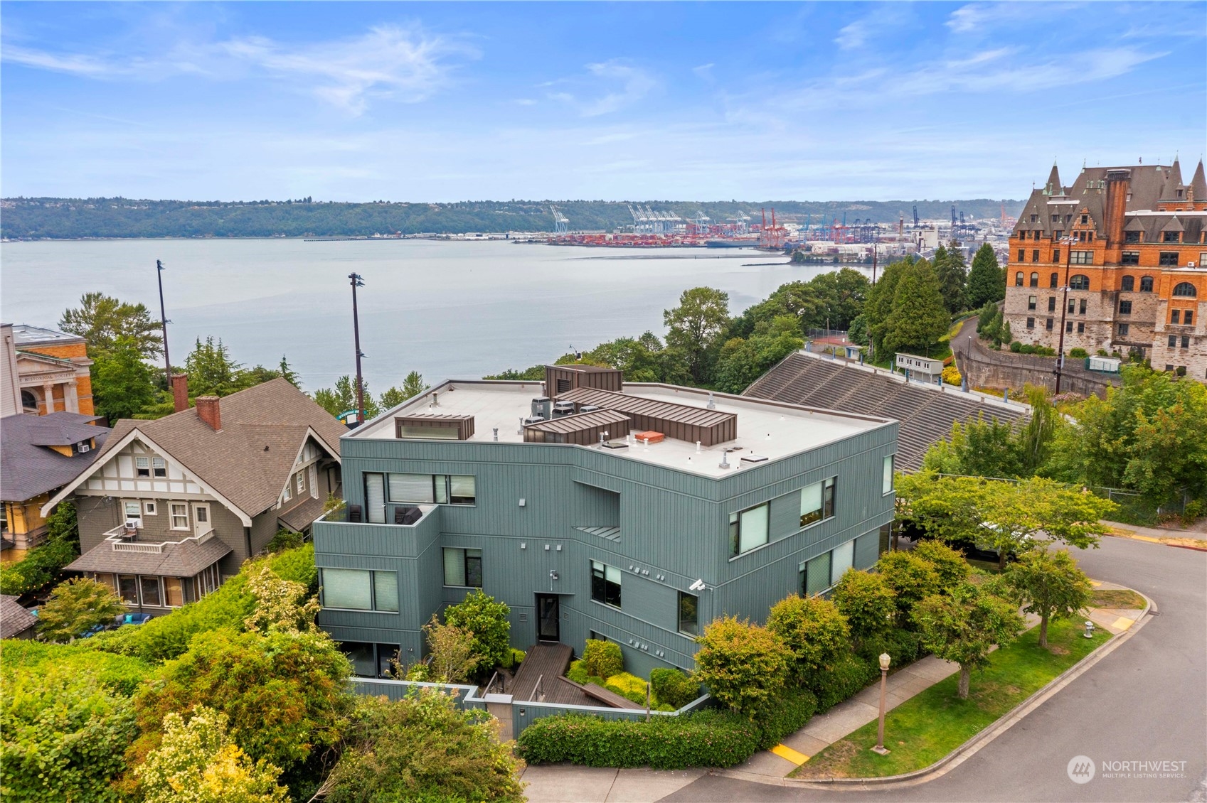 an aerial view of a house with a garden and lake view