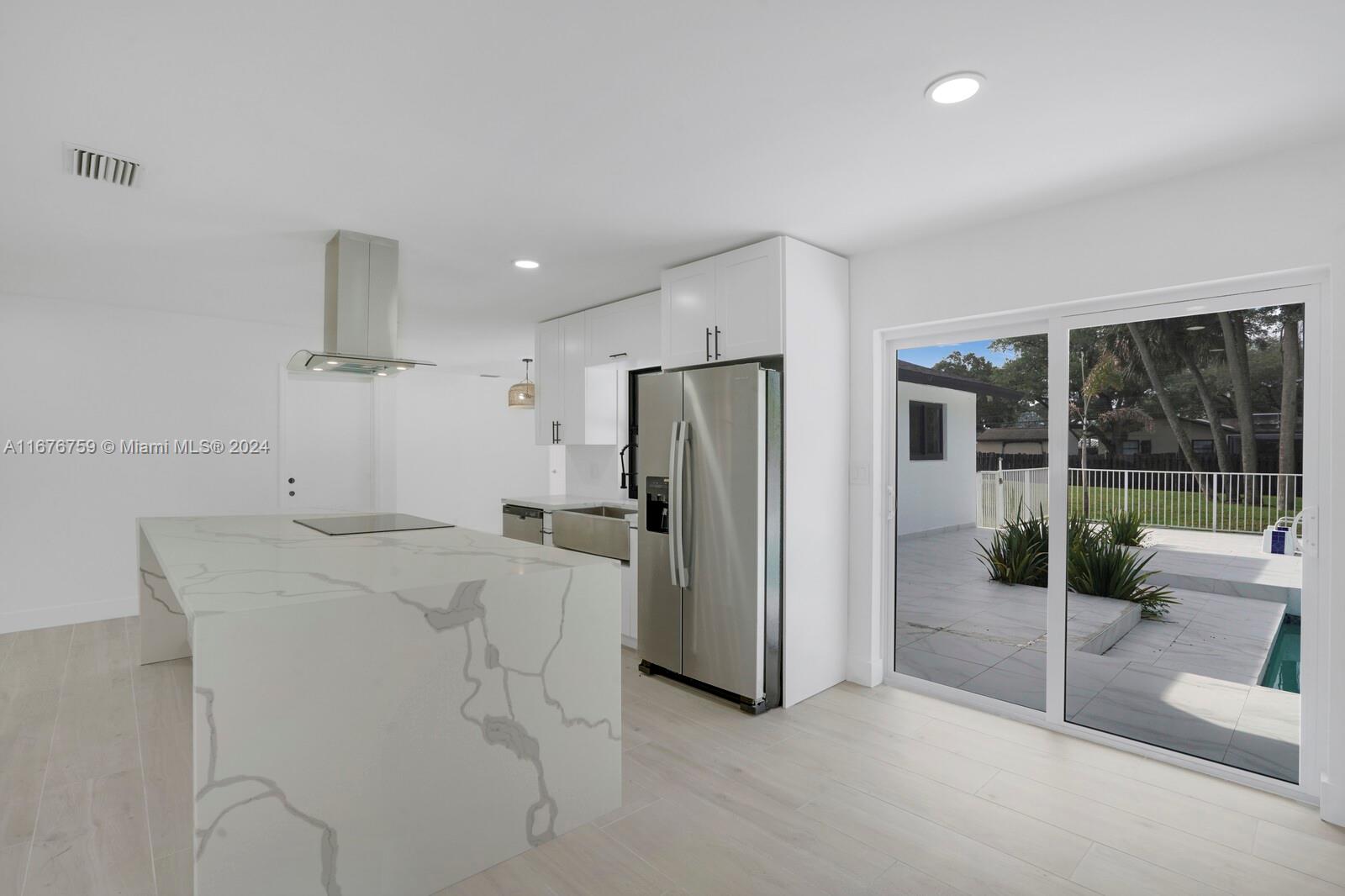 a kitchen with refrigerator and window