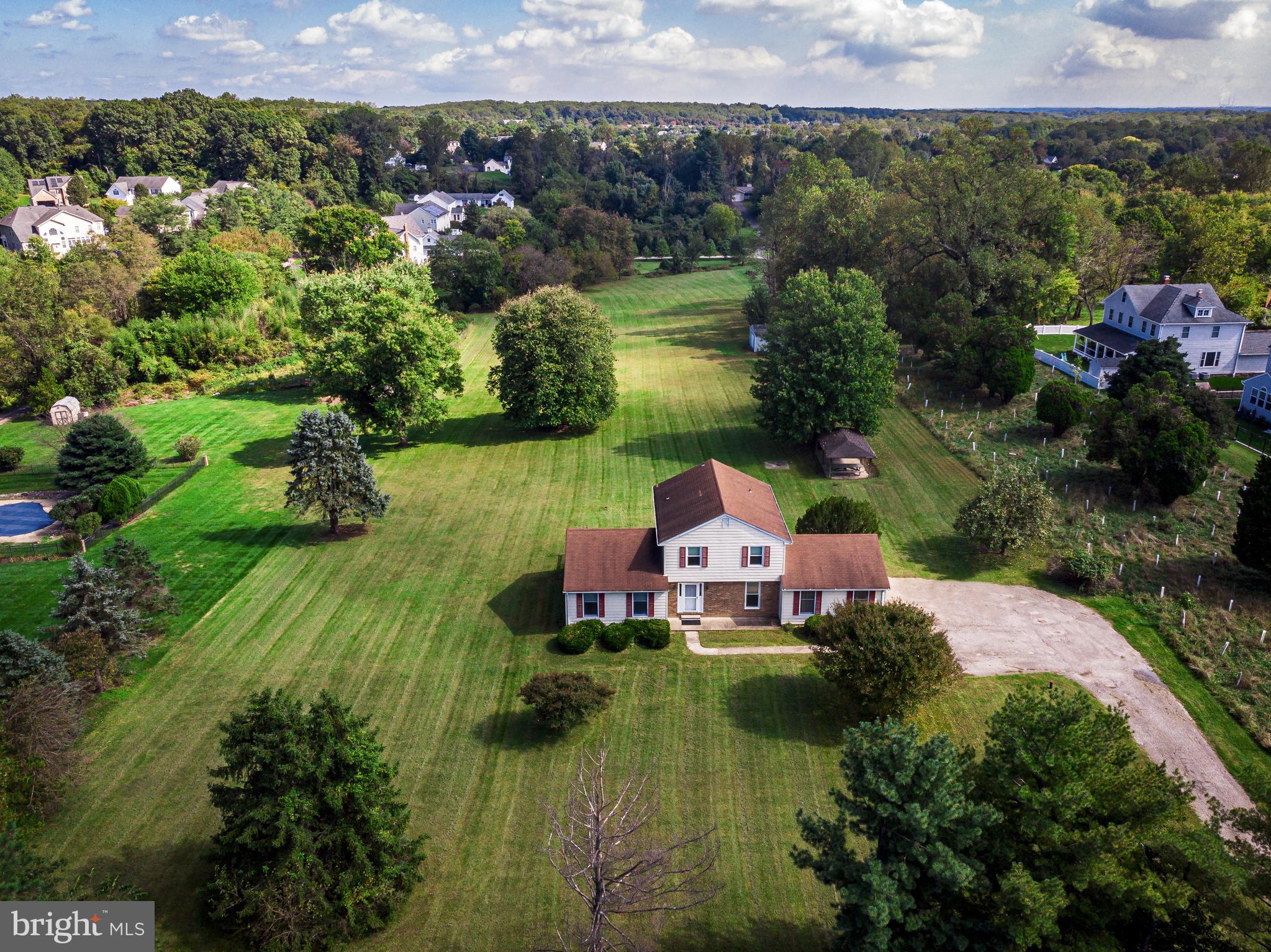 an aerial view of a house with a garden and lake view