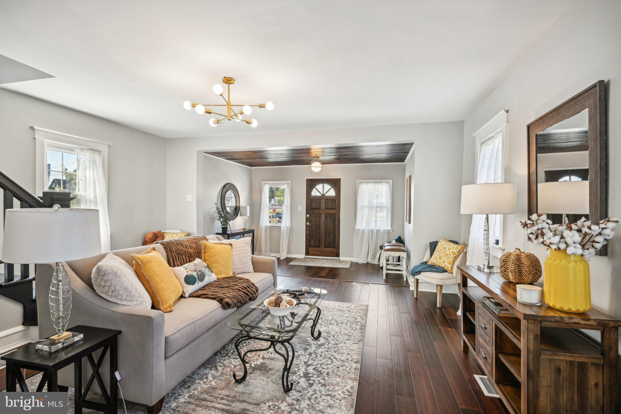 a living room with furniture fireplace and chandelier