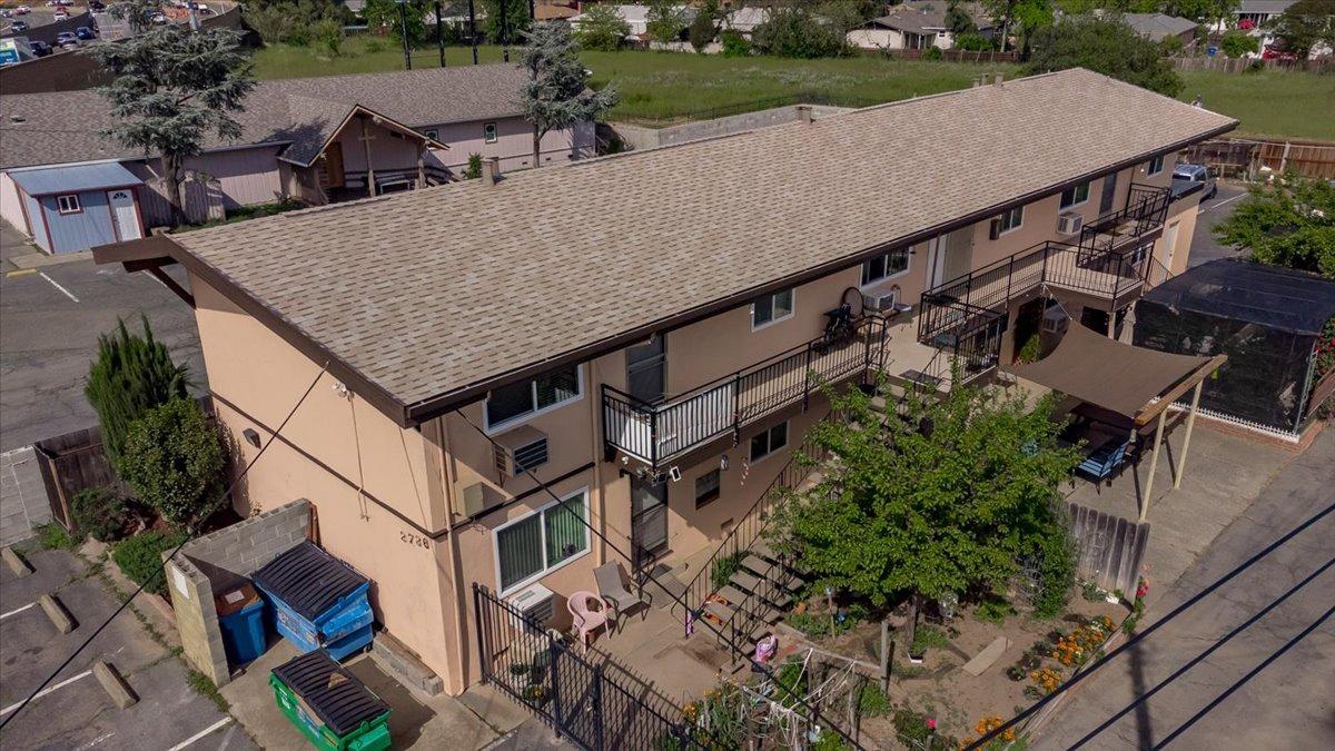 an aerial view of a house with balcony and trees