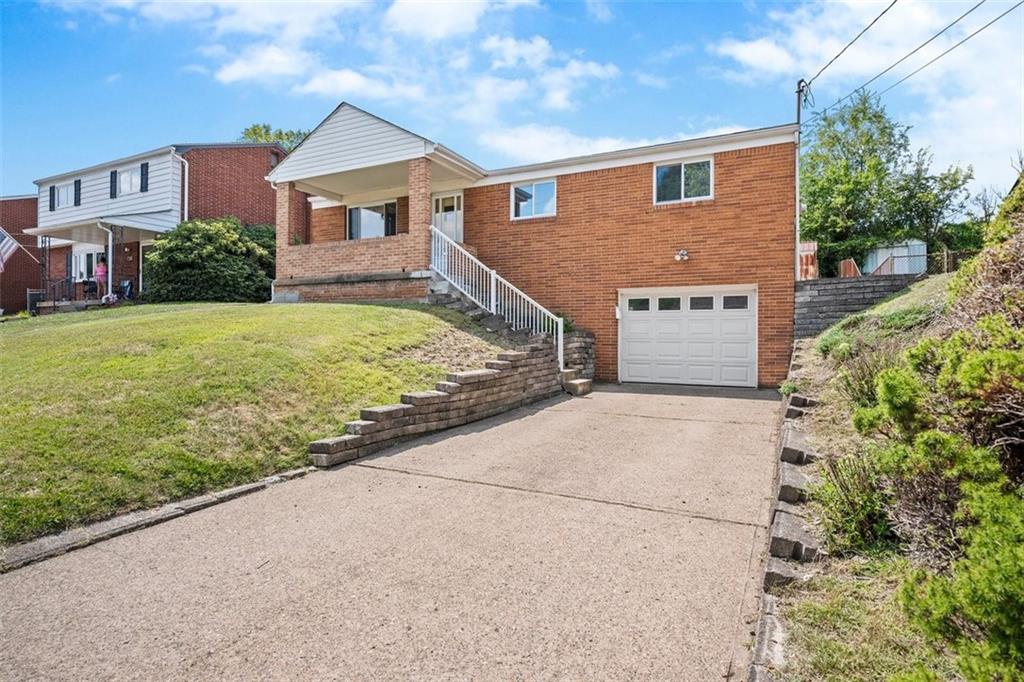 a view of a house with a yard and garage