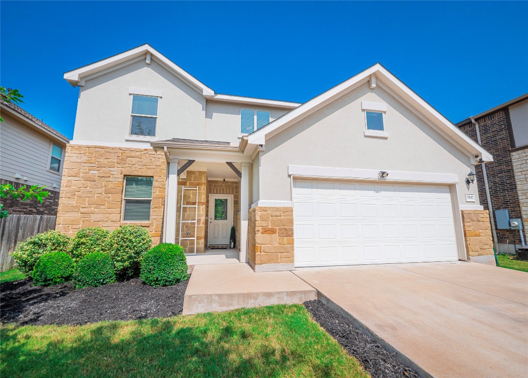 a front view of a house with a yard and garage