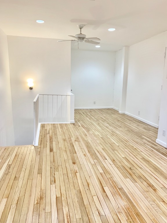 a view of a bedroom with wooden floor and balcony