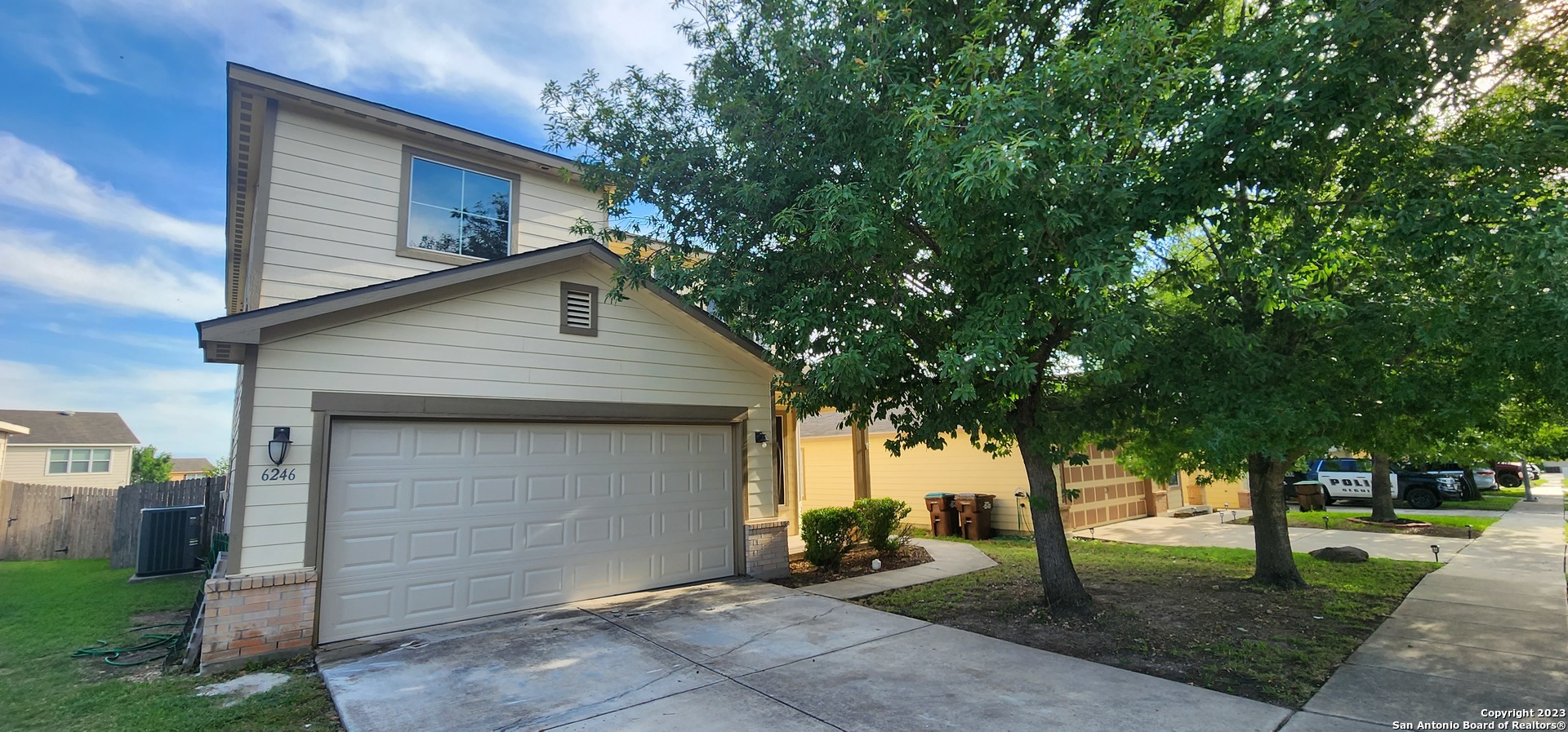 a house that has a tree in front of the house