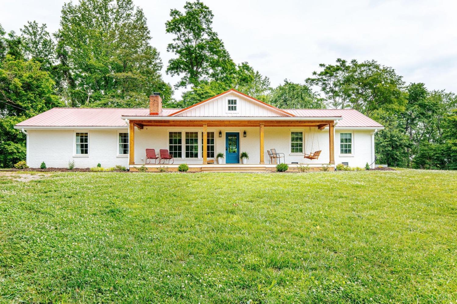 a front view of a house with a yard table and chairs