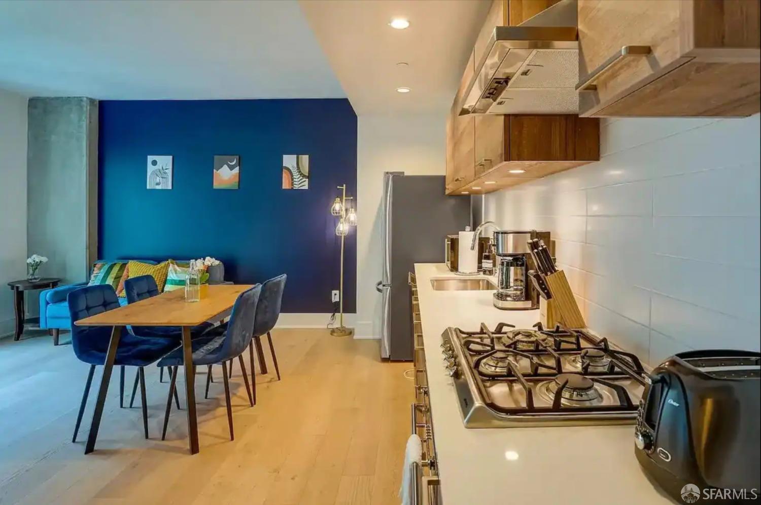 a kitchen with stainless steel appliances kitchen island granite countertop a sink and a refrigerator