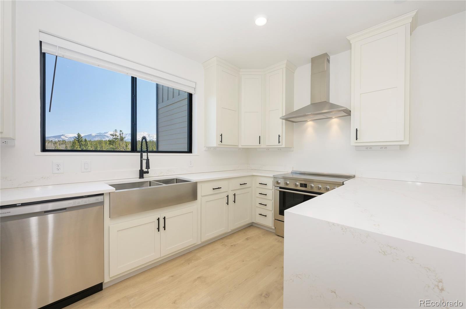 a kitchen that has a sink and a stove