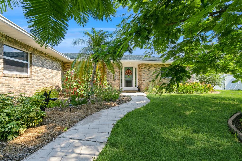 a front view of house with yard and green space