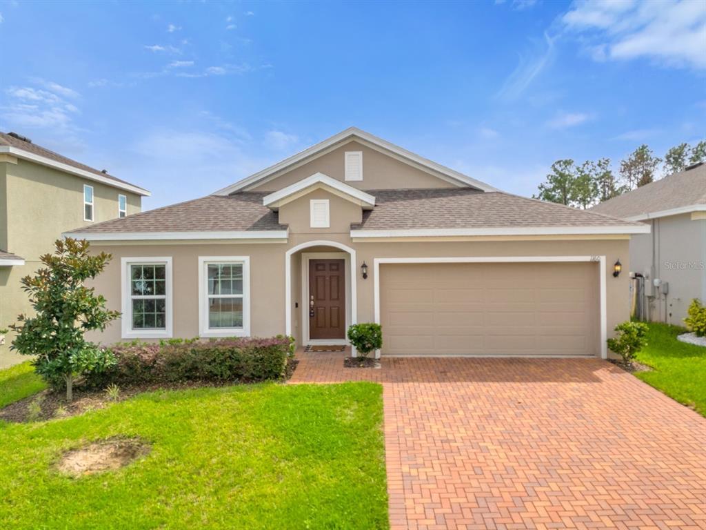 a front view of a house with a yard and garage