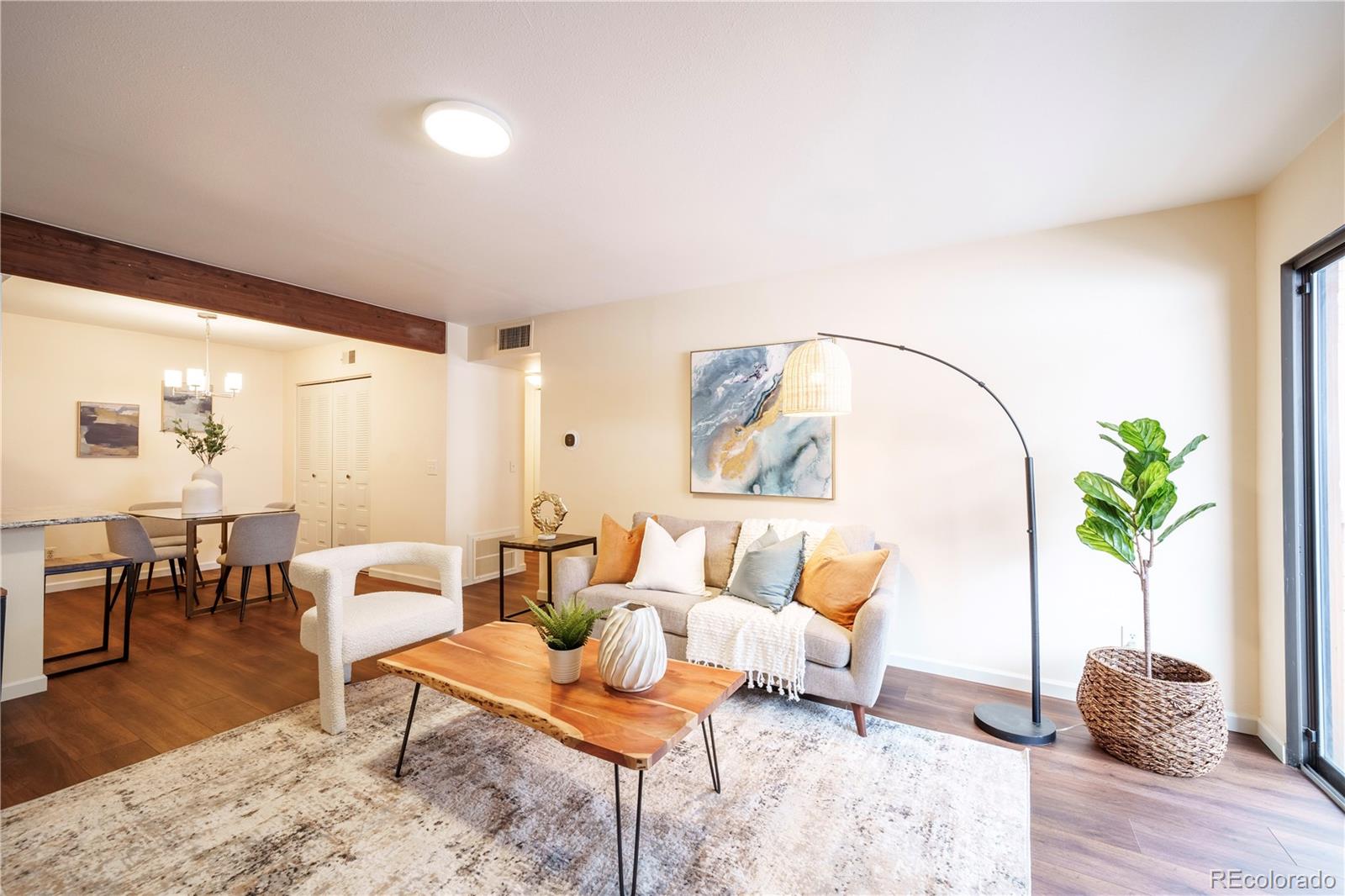 a living room with furniture and wooden floor