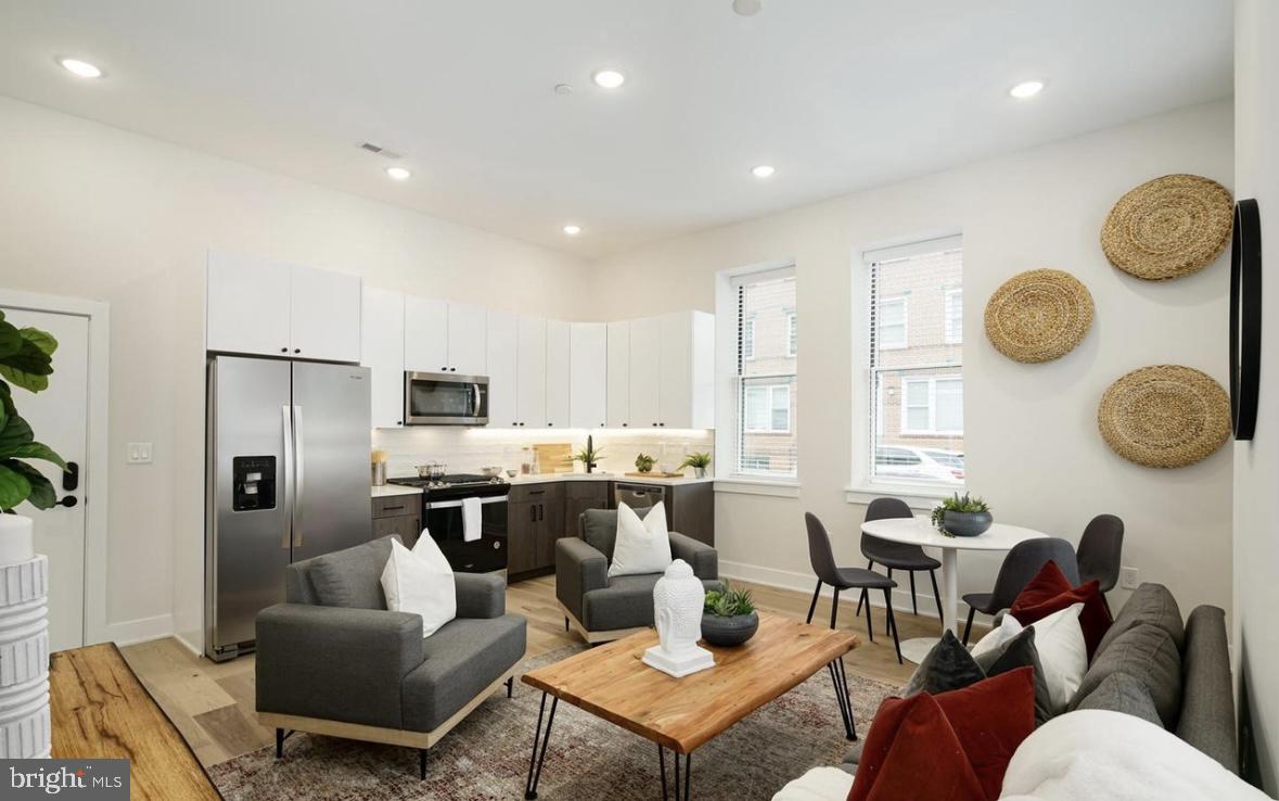 a living room with lots of furniture and a large window