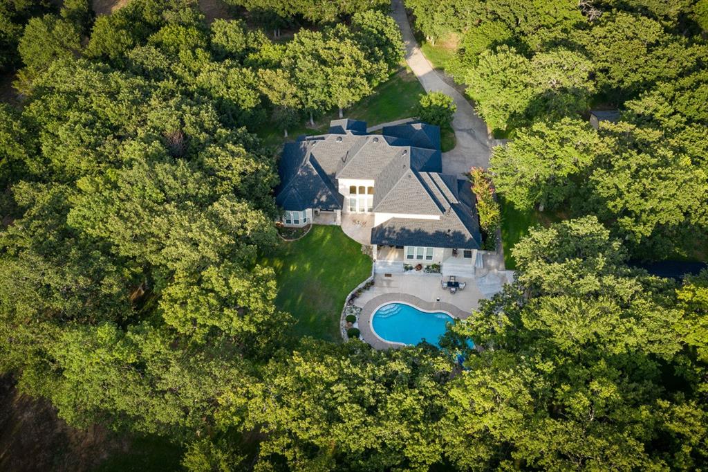 an aerial view of a house with a yard