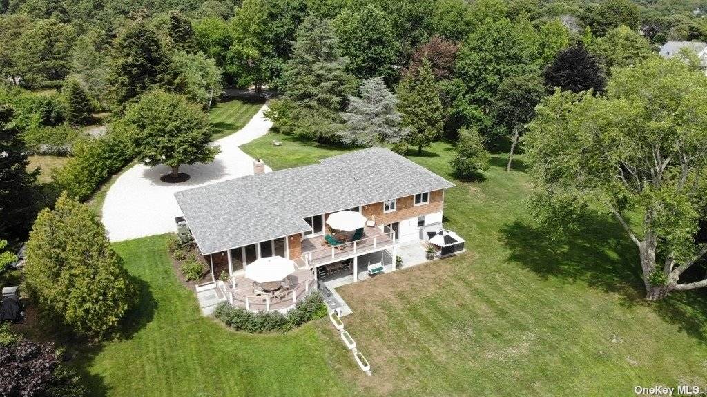 an aerial view of a house with yard table and chairs