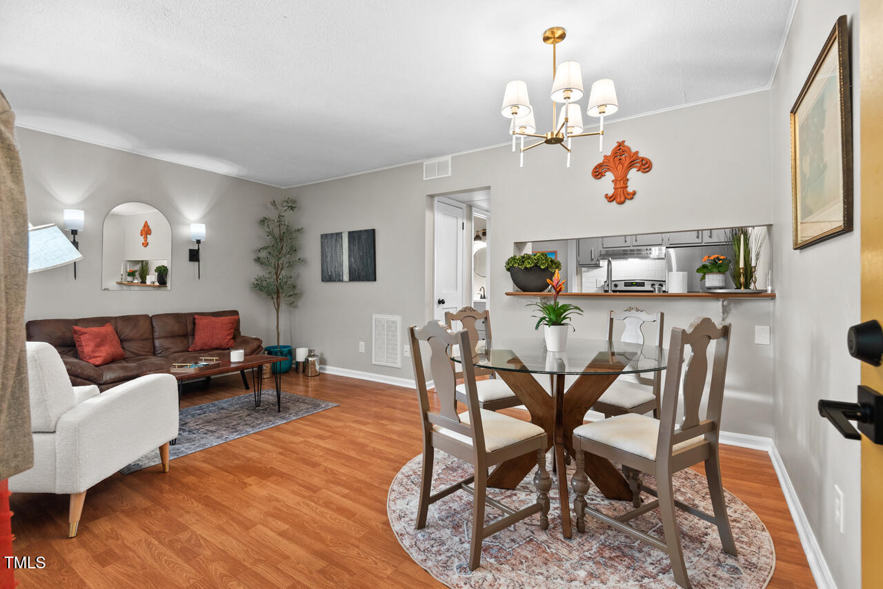 a living room with furniture and kitchen view