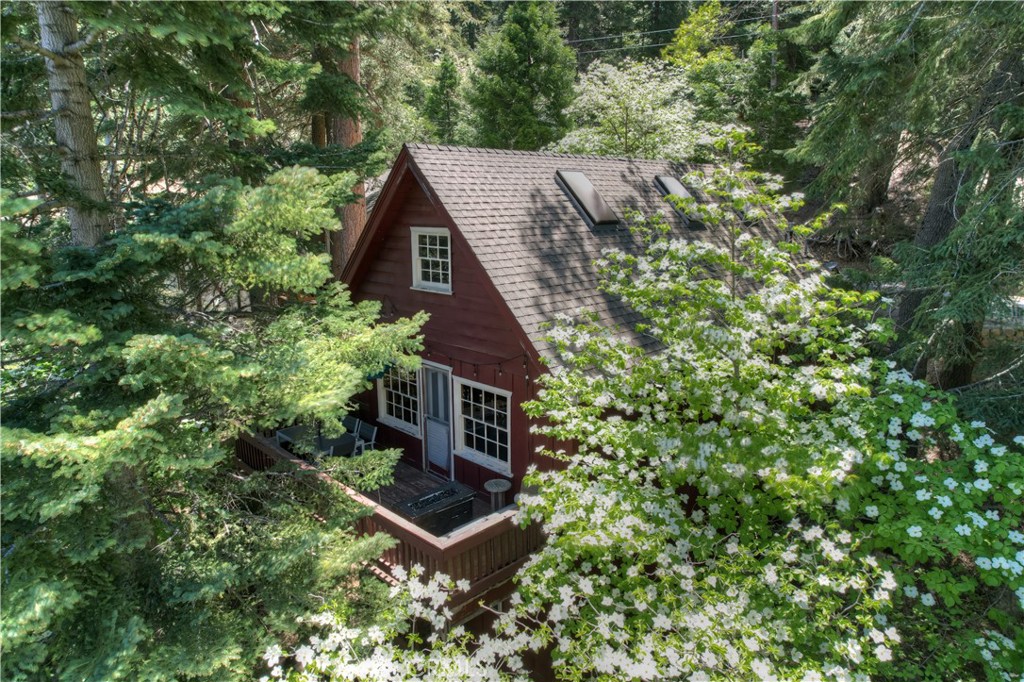 a view of a wooden house with a tree