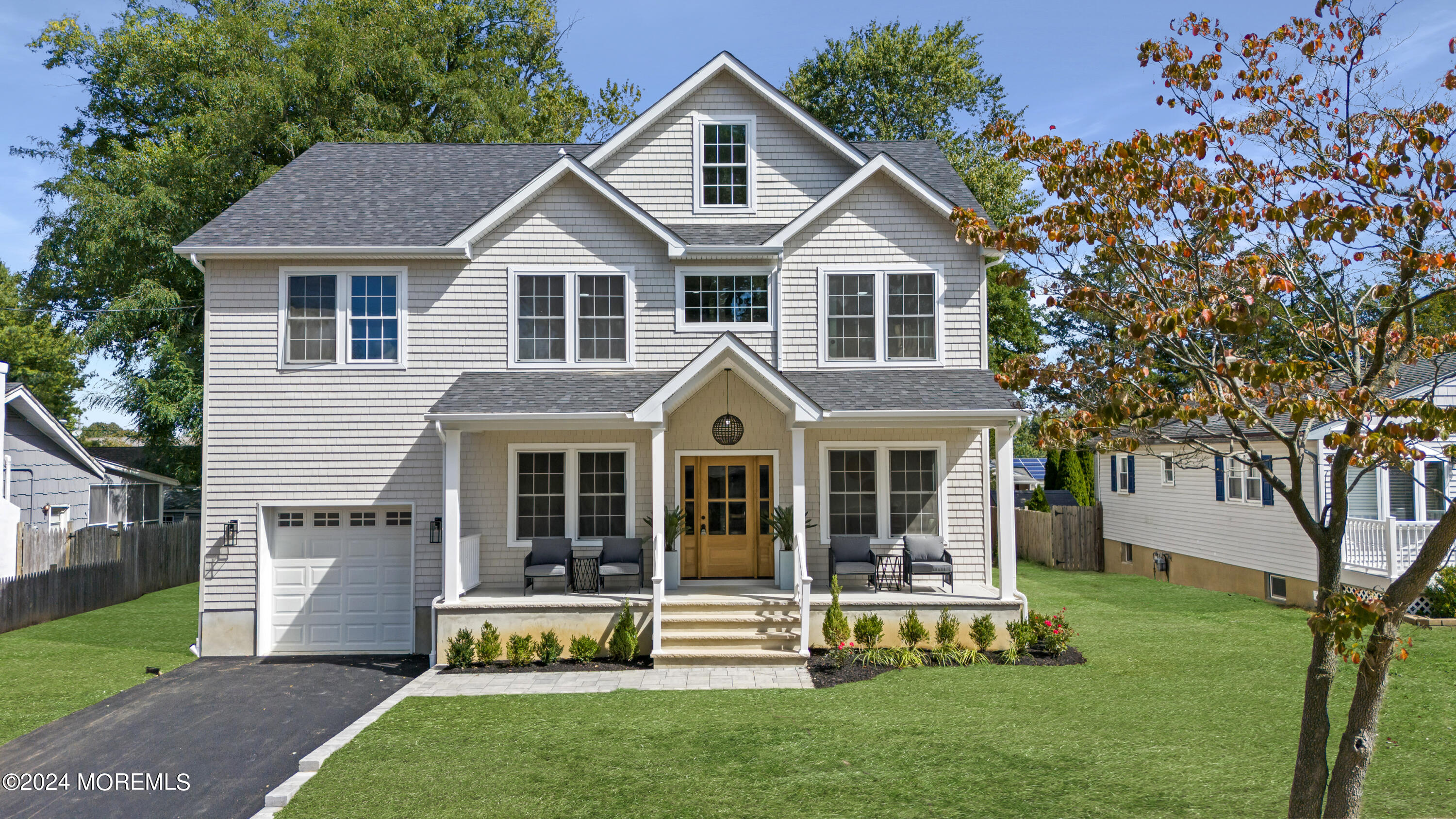 a front view of a house with a garden and porch