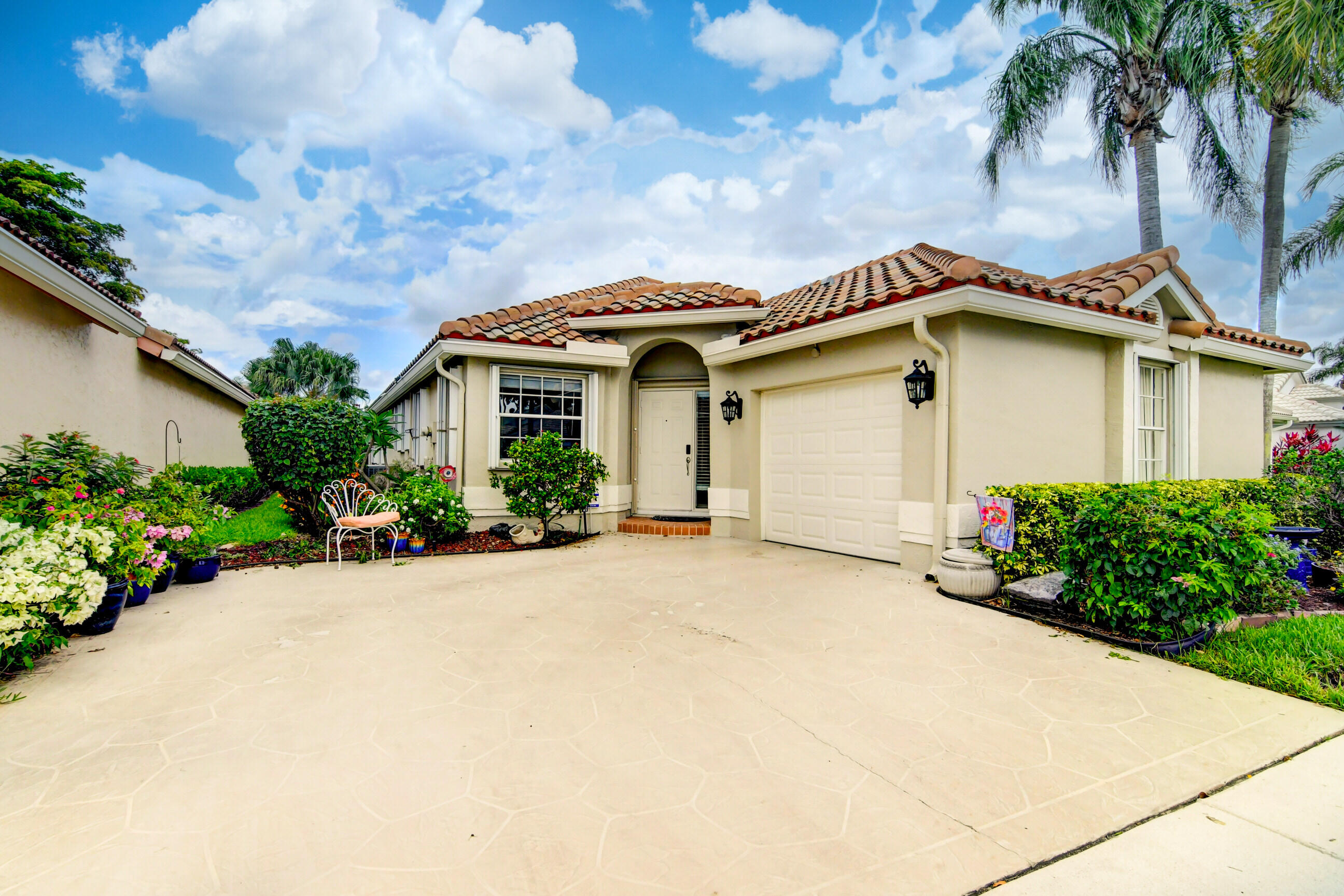 a front view of a house with a garden