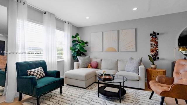 a living room with furniture and a large window