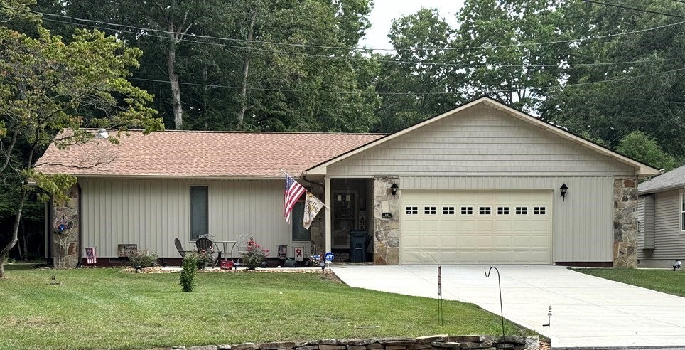 a view of a house with a yard and garage