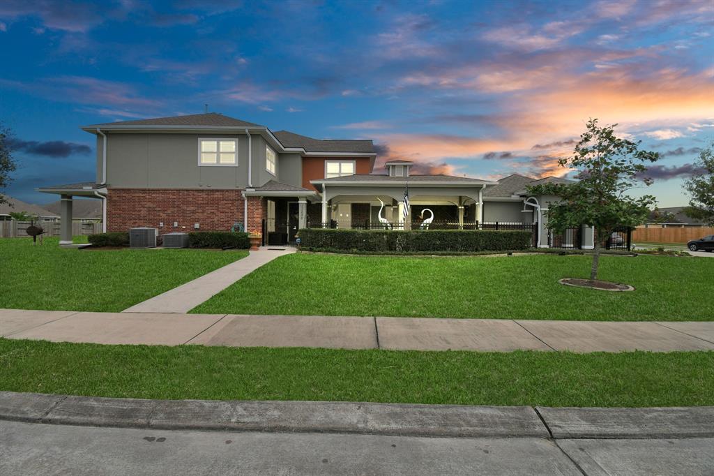 Charming corner townhouse in the prestigious Villages at Champions Gate, featuring a private walkway to an inviting gated patio.