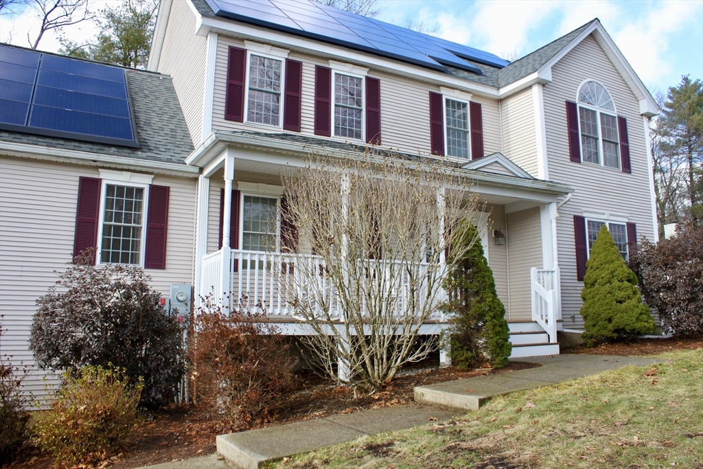 a view of a house with a small yard and plants