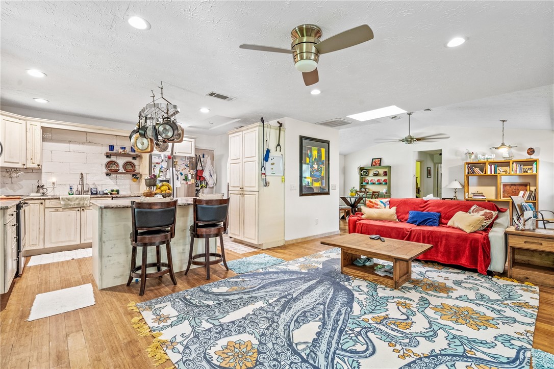 a living room with kitchen island furniture and a chandelier