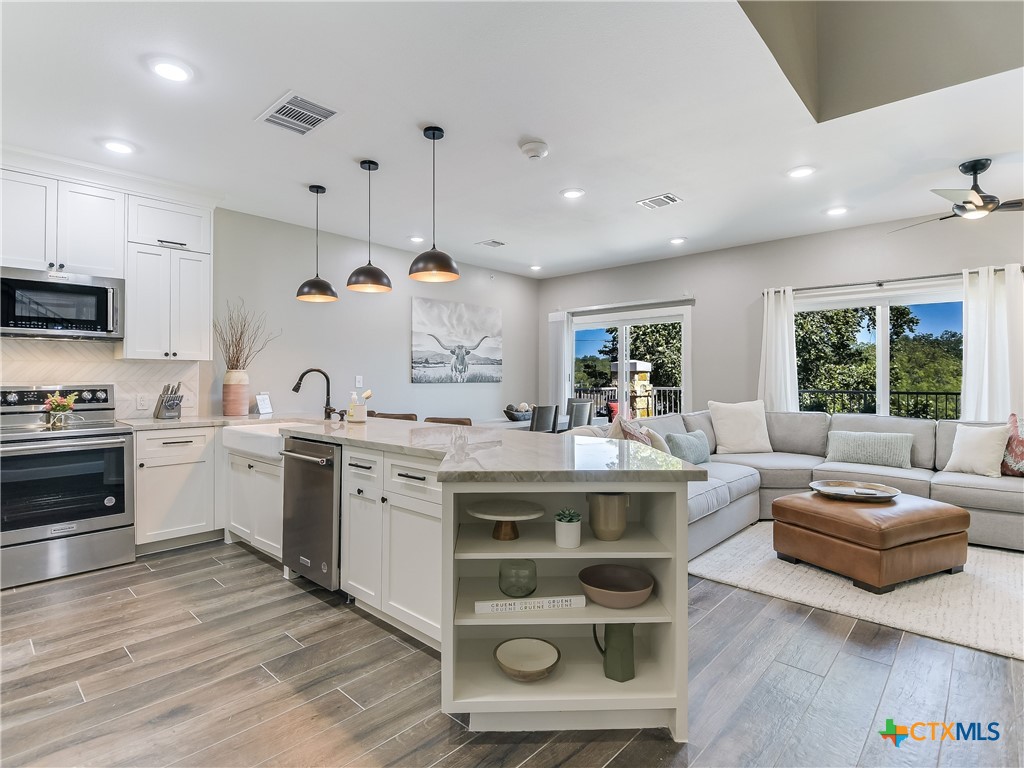 a living room with kitchen island furniture and a wooden floor