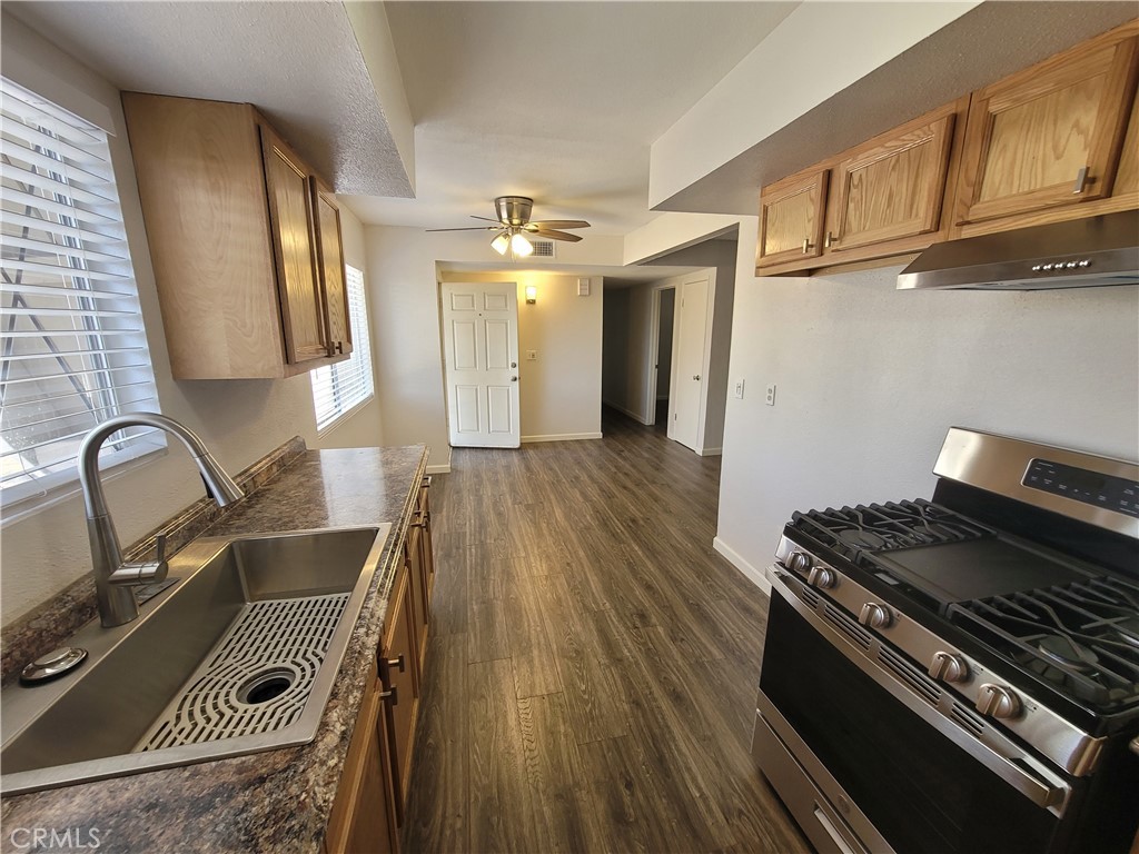 a kitchen with wooden cabinets and a stove top oven