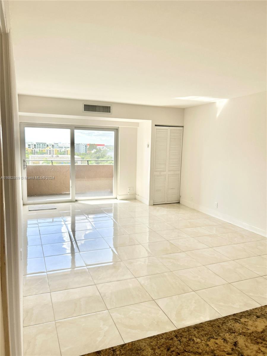 a view of an empty room with a window