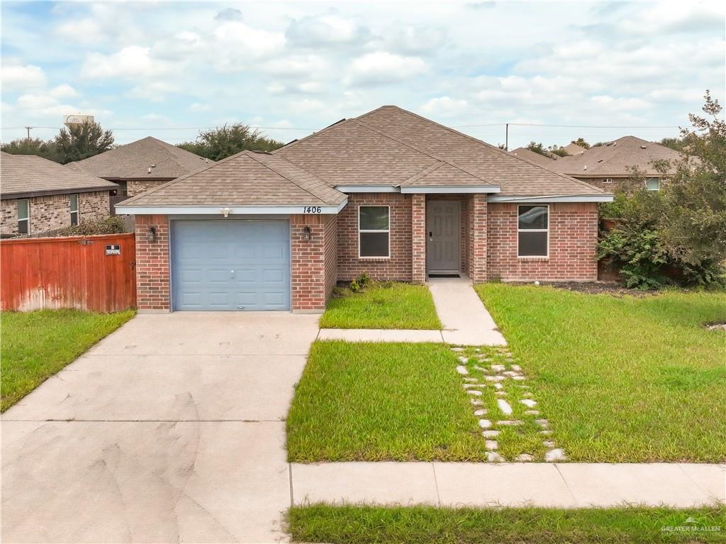 a front view of house with yard and garage