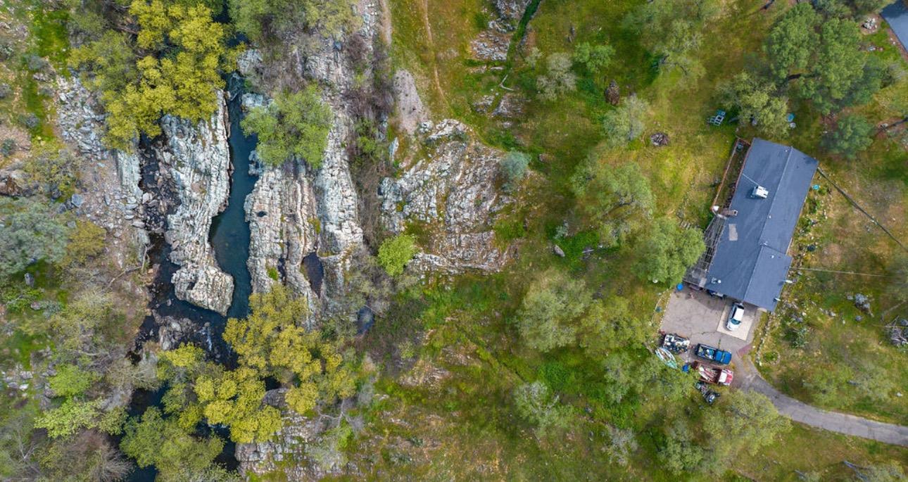 an aerial view of a house with lots of trees