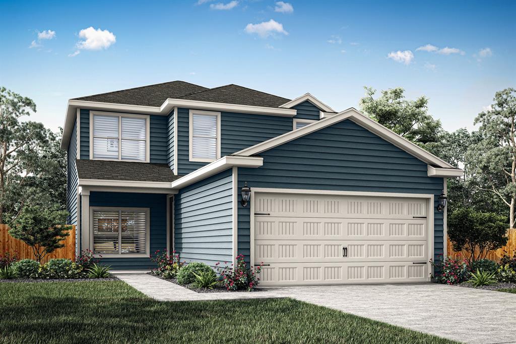 View of front of home with a garage and a front lawn