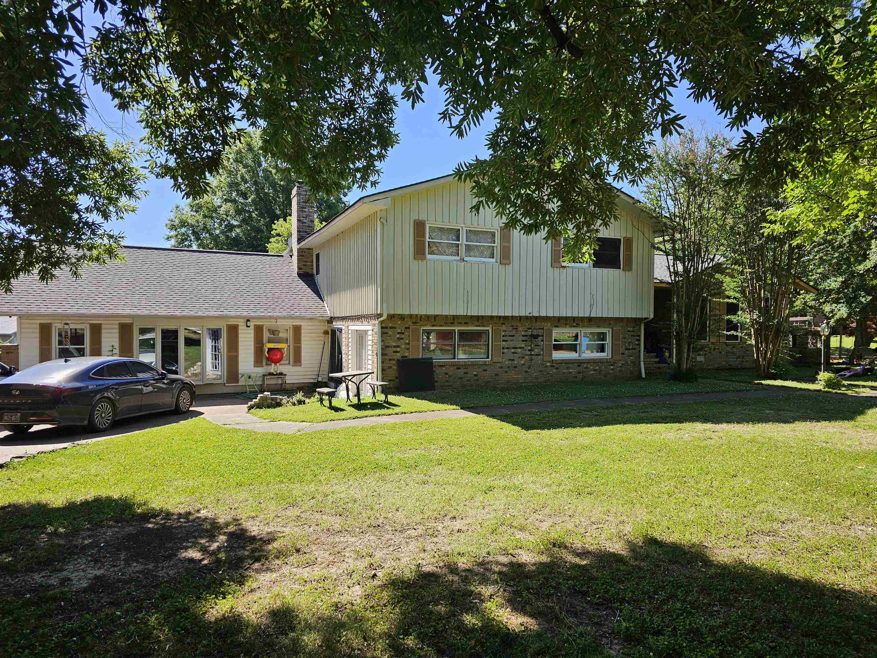 a view of a house with swimming pool and a yard