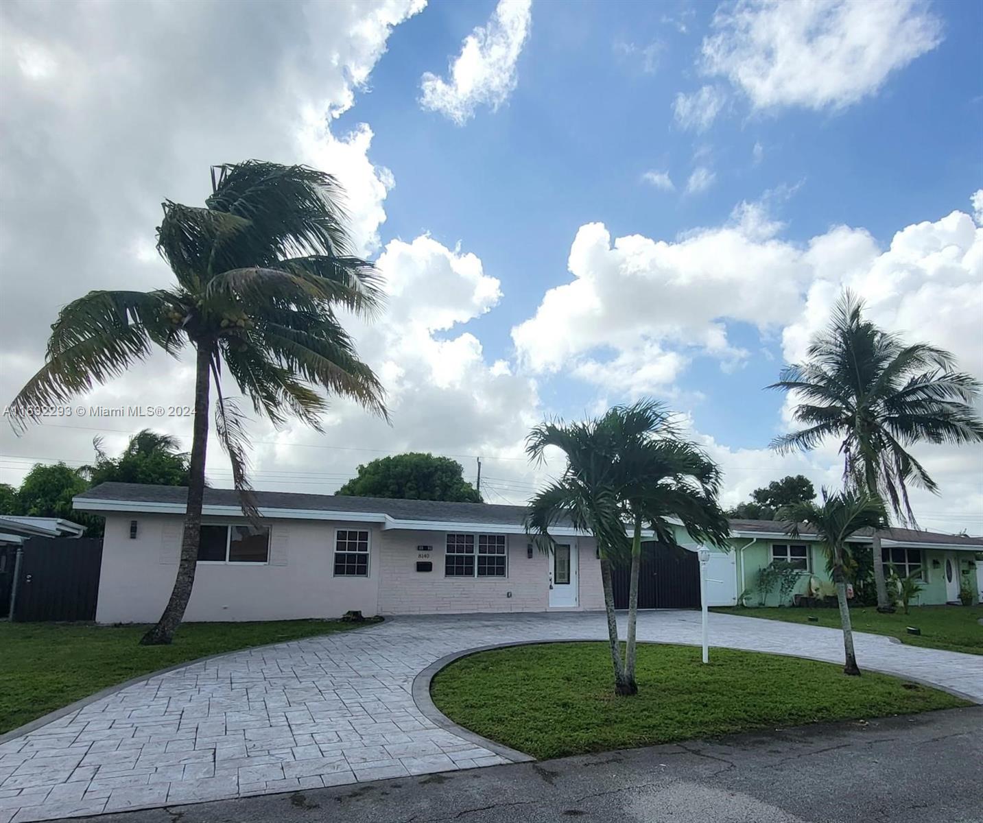 a front view of a house with a garden and yard